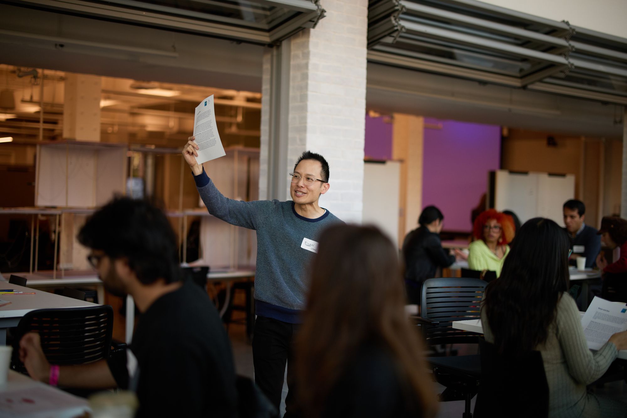 Evan Chan, one of the workshop presenters, shows a handout to the room.